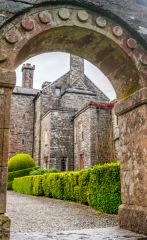The castle through a garden archway