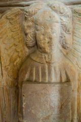 Carved angel on the font