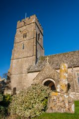 The 15th century tower and churchyard cross