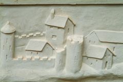 Plaster panel of a fortified town