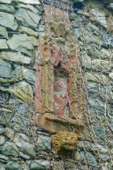 Statue niche above the arch, supported by a lion carving