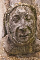 Carved head on the church exterior