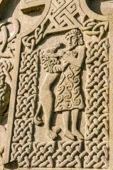 Man wrestling a lion carving
