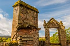 A ruined window and chimney stack
