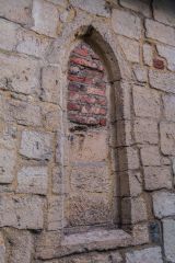 A blocked lancet window in the north chapel wall