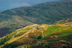 Sunlight playing across Loughrigg Fell