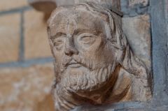 Carved head on the piscina