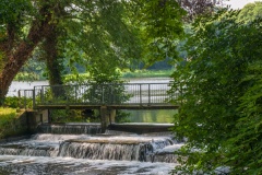 A shady weir and the 15 acre lake