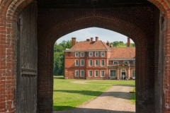 The house viewed through the gateway arch