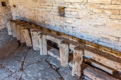 A worn wooden ladder in the entrance bay
