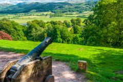 A cannon looks out from the castle entrance