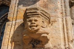 Carved head on the south exterior wall