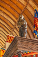 Carved figure on the pew roof