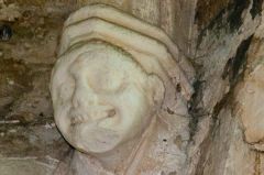 A grotesque corbel head carving