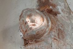 Carved human head corbel