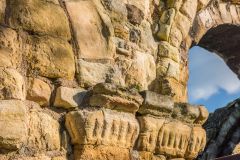 Carved capitals beside a Romanesque arch