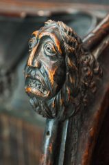 Carved medieval bench end in the chancel