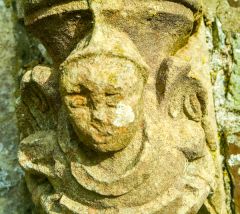 Carved head in the churchyard