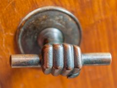 A cabinet handle in the shape of a hand