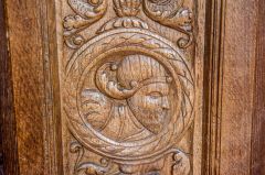 Carved head on the font cover