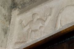 Tarrant Rushton, St Mary's Church, Man holding a book on the carved door lintel