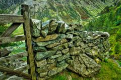 A stone wall and gate leading to the falls