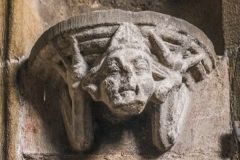 Carved head under a statue niche