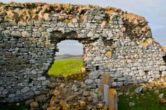 A ruined wall and window opening