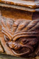 Grimacing misericord carving