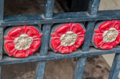 Tudor roses decorate the wrought-iron gates