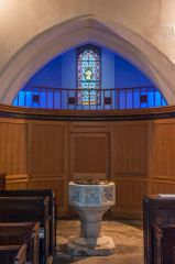 The 13th century tower arch and font