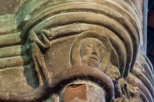 Amusing carved figures, nave pillars