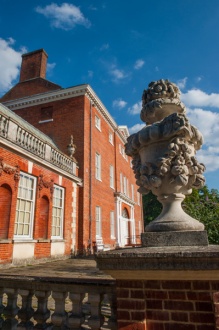 House front and classical urn