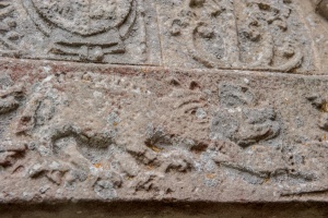 Carving of a boar being hunted