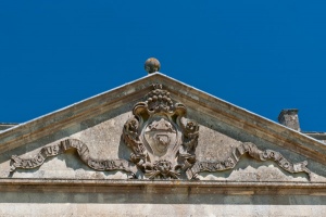 The St John family crest over the house entrance