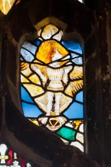 Stained glass figure of a woodwose