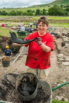 An archaeologist displaying a fresh find