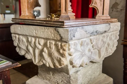 The richly-carved font