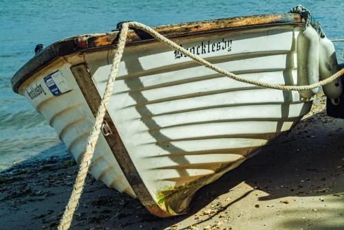 A boat drawn up on the shore at Shipstal Point