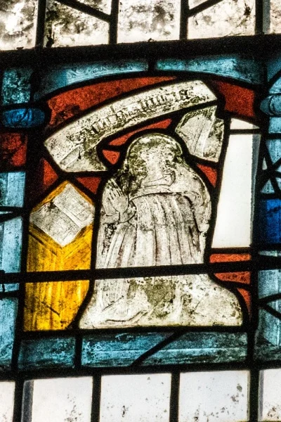 Medieval stained glass of an abbot praying