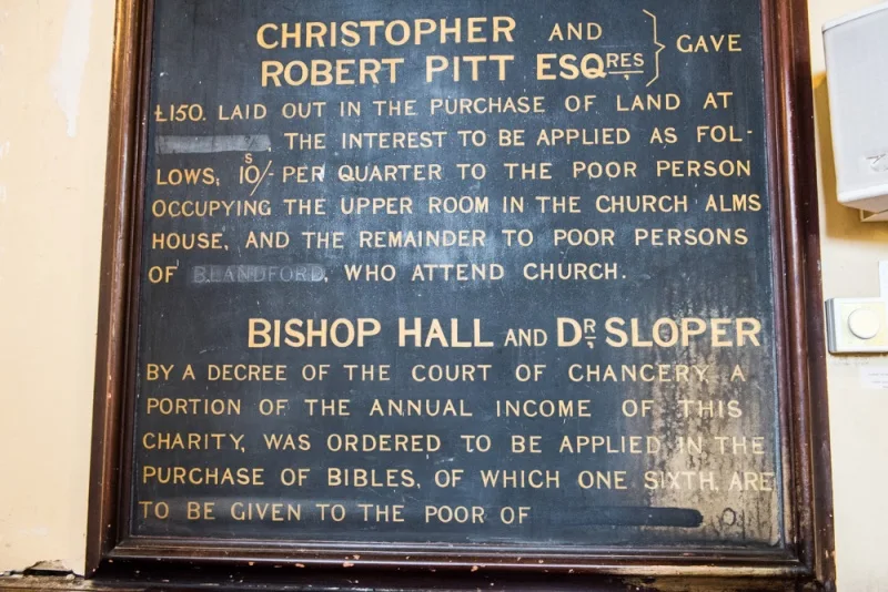 Dedication board with the town name painted out