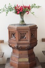The wooden-clad font
