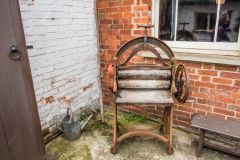 A laundry mangle outside the Master's House