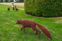 A wire fox sculpture in the garden