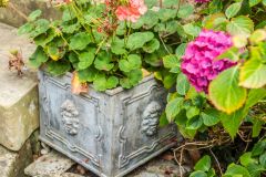 A lead planter beside the entrance