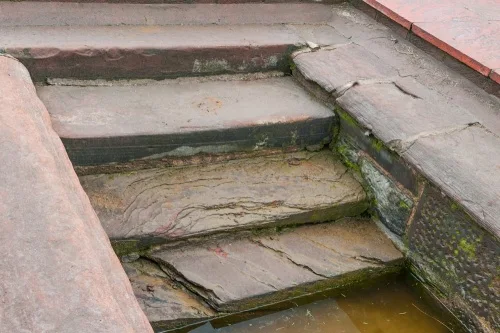 Worn stone steps leading down into the well