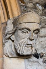 Carved head of a king on the south porch