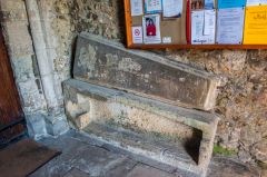Stone coffin and lid in the porch