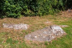 Several prone stones lie near the dolmen