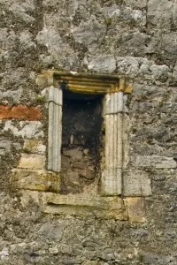 Blocked window over the arch